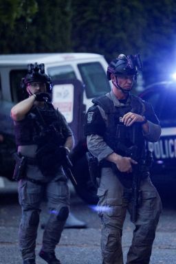 Police officers guard an area near Seattle Center, which was hosting a Bite of Seattle food festival, in Seattle, Washington, Sunday, July 26.