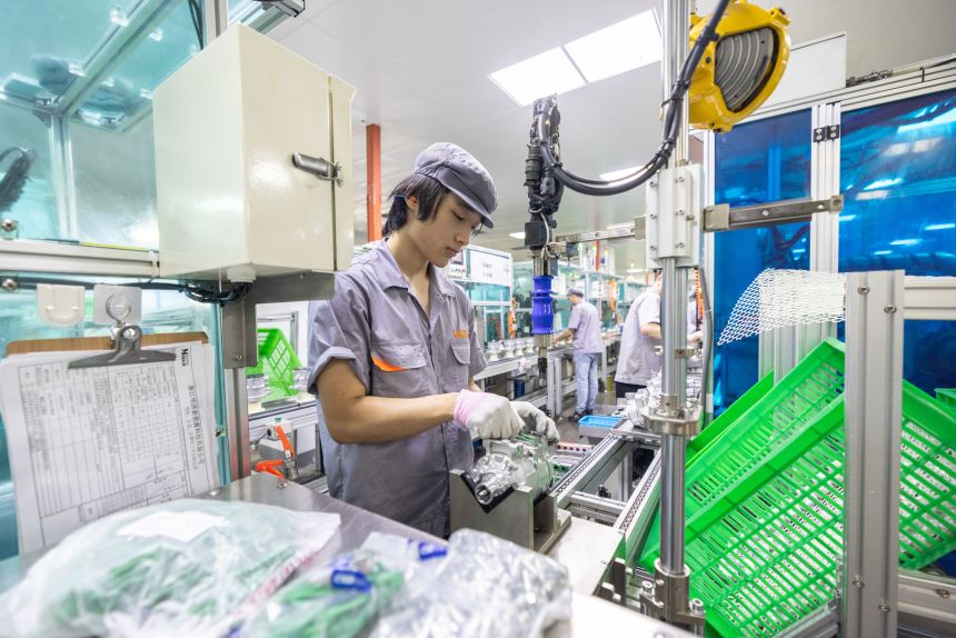 Workers produce air conditioning parts in Huzhou, China, on July 24, 2026.