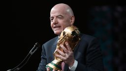 WASHINGTON, DC - JANUARY 29:  FIFA President Gianni Infantino holds the FIFA World Cup Trophy as he addresses the winter meeting of The U.S. Conference of Mayors on January 29, 2026 in Washington, DC. Infantino promoted the 2026 FIFA World Cup, which will be co-hosted by the United States, Canada, and Mexico, highlighting its potential benefits for host cities and communities. (Photo by Alex Wong/Getty Images)