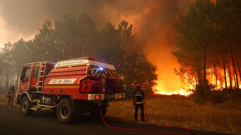 TOPSHOT - Firefighters try to extinguishing fires burning trees using a wildland water truck near Le Porge, southwestern France on July 23, 2026. A highly virulent wildfire has swept through more than 2,000 hectares since July 22, 2026 near the Arcachon Basin (Gironde), where nearly 12,000 residents and tourists have been evacuated in total from this area of the Landes de Gascogne forest, already devastated by flames in 2022. (Photo by ROMAIN PERROCHEAU / AFP via Getty Images)
