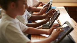School students in class working with tablets